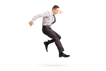 Young businessman jumping in the air