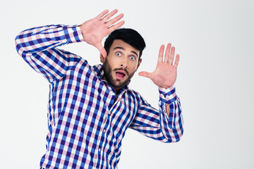 Naklejka premium Portrait of a scared man with raised hands up