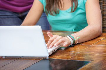 pretty student girl doing homework at home with a laptop