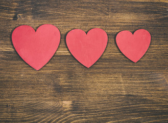 Obraz na płótnie Canvas Red hearts on wooden background
