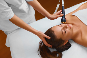 Face skin care. Woman lies on a table in a beauty spa getting a