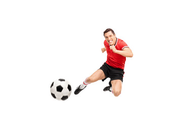 Fototapeta na wymiar Young football player shooting a football