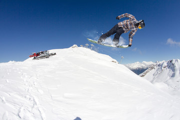 Flying snowboarder on mountains