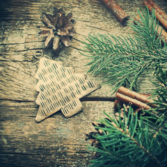 Vintage Christmas Fir Tree Toy, Pine Cones, Cinnamon, Branches of Coniferous on Wooden Background