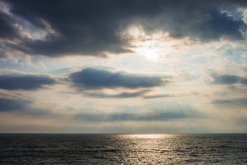 Fototapeta na wymiar Sea where light shines from a cloud