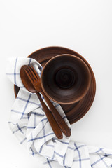 empty clay bowls on a white background and a kitchen towel