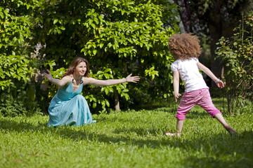 Fototapeta premium Mother and daughter are enjoying on grass at park