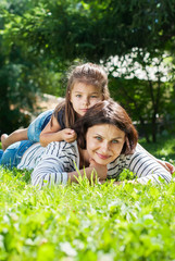 Fototapeta premium Mother and Daughter playing on Grass