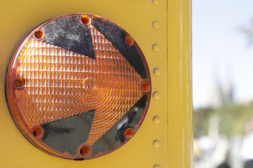 Right turn light of a traditional yellow school bus on the street