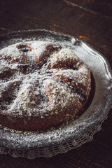 Cake with icing sugar on the vintage metal plate vertical