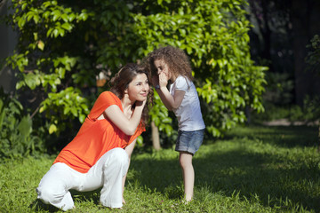 Fototapeta premium Mother and daughter are enjoying on grass at park