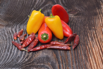 Colored peppers on wooden background