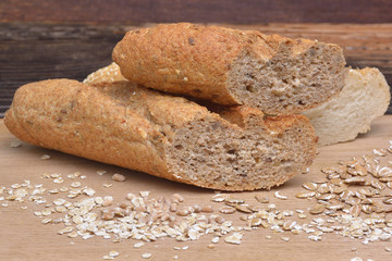 Bread and grains on wooden background