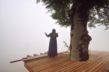 Silhouette of woman in misty fog