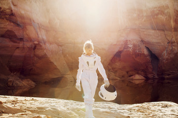 Naklejka premium futuristic astronaut without a helmet in rays of another sun