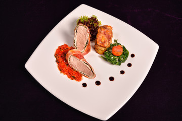 pork tenderloin in bacon wrap with tomato sauce flavored with ro