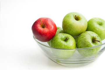 red apple between green apples