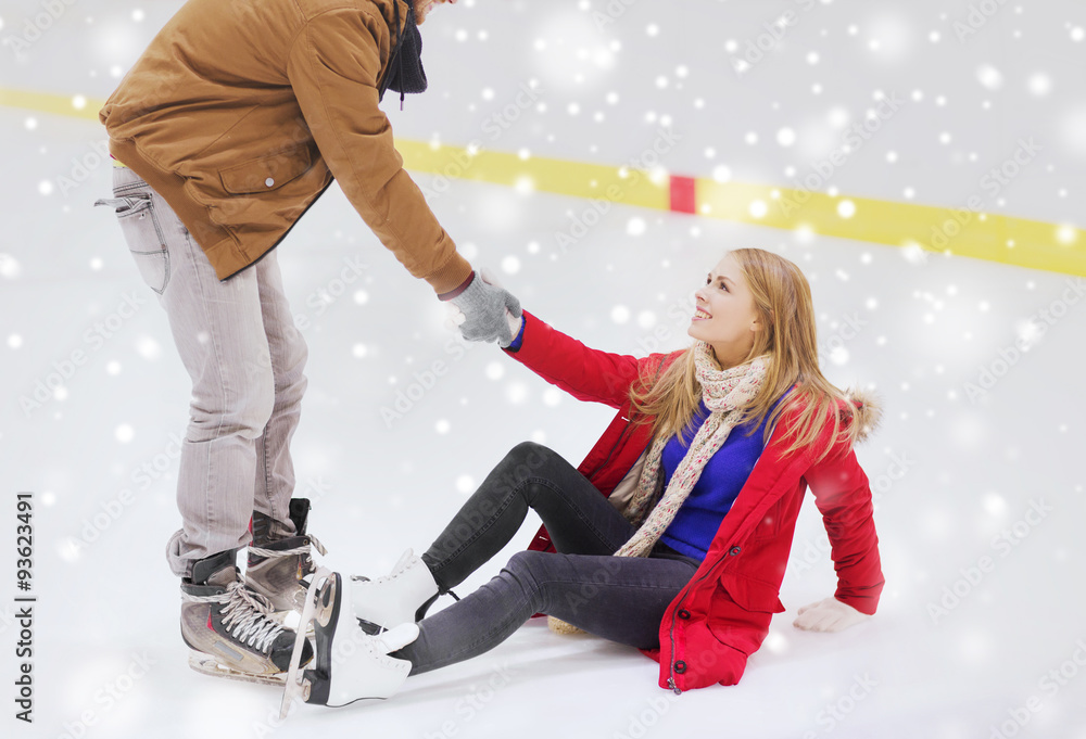 Sticker man helping women to rise up on skating rink