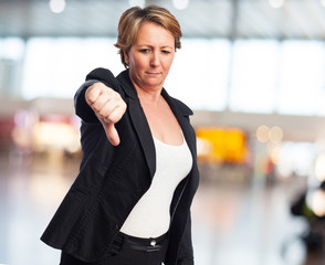 portrait of a mature business woman with thumb down