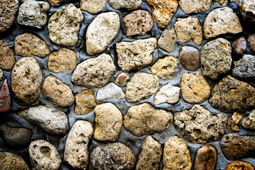 Texture of stone coquina wall in cement high contrasted with vignetting effect