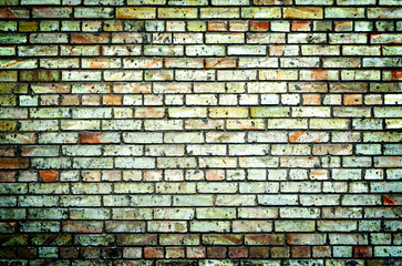 Texture of multicolored brick wall high contrasted with vignetting effect