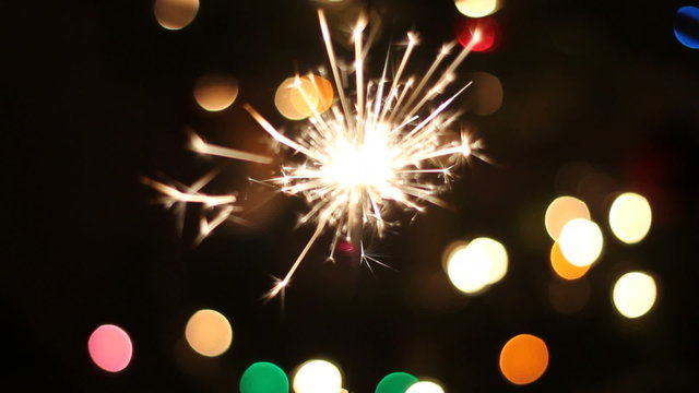 Fireworks with defocussed Christmas tree in the background. 