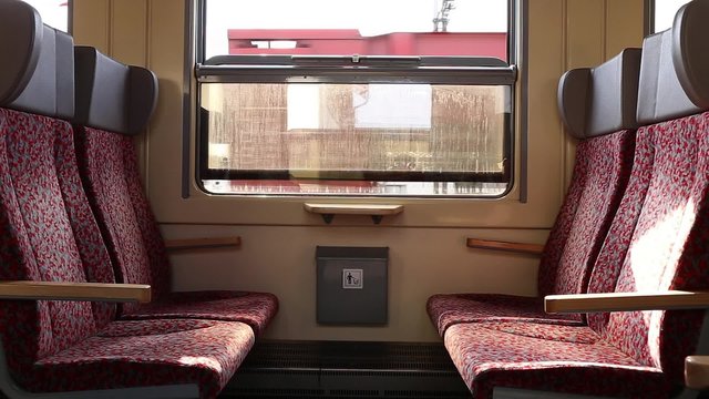 Footage of a empty seats in old train carriage. Motion shot/leaving station