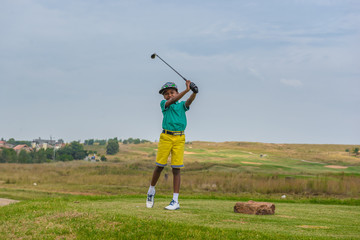Boy playing golf. South Africa. 

