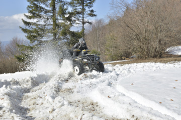 man driving a quad bike in the winter field © brszattila