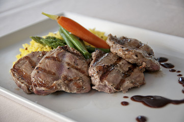 grilled pork chop meal with seemed vegetables and rice