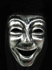 Smiling carnival face mask, part of a Halloween costume.