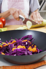 Hands cutting cucumber. Preparation for salad or wok.Healthy vegetables