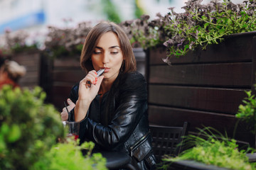 beautiful glamorous brunette smoke electronic cigarette