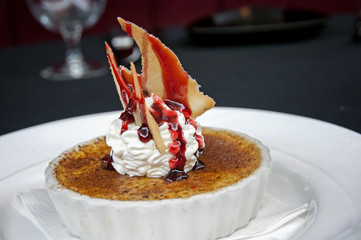 restaurant creme brûlée with whip cream and fruit 