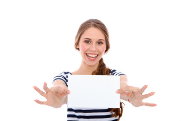 Fototapeta premium Student girl showing white blank sheet - copy space, isolated over background