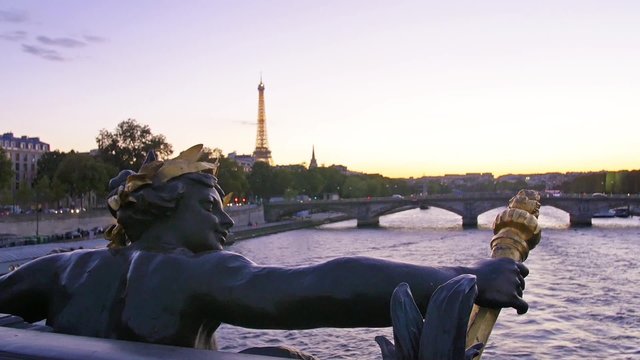 Paris, statue on Alexander III bridge on the river Seine with the Eiffel tower on the background