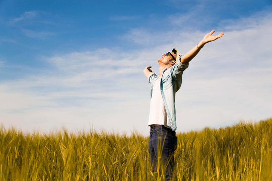 boy feels free putting his hands to the sky,in a countryside-lifestyle,outdoor and emotional concept