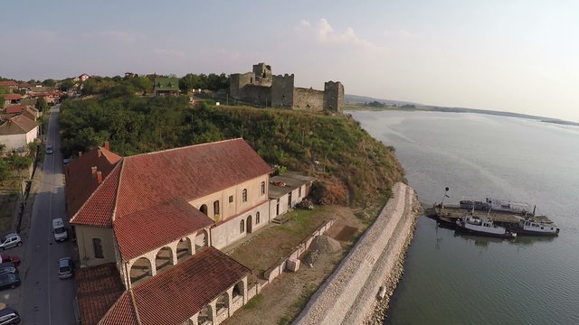 Smooth flight over the ferry, tavern and old fortress.