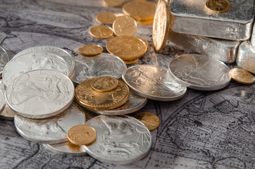 Gold & Silver Coins with Silver Bars on map