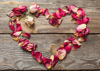 dried rose petals on wooden table