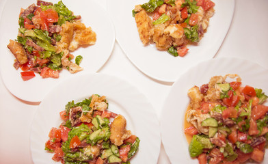 4 plates with salad from cheese, sausages and vegetables