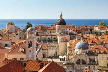 Fototapeta na wymiar Old Town's skyline with red roofs and churches' and cathedrals' towers in Dubrovnik, Croatia, viewed slightly from above.