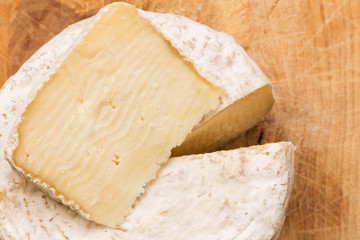 slice of caciotta over whole caciotta cheese