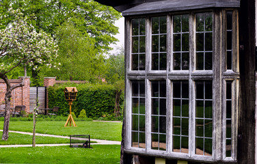 Tudor house exterior detail built in 1590 detail of window and garden outdoors Blakesley hall...