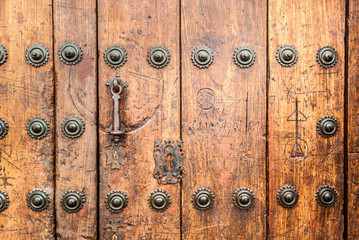 Old locked door with ancient iron handle door