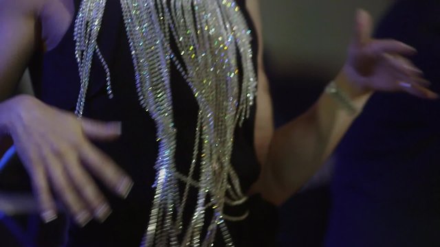 Young, beautiful, attractive girl dances on the stage close up