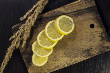 sliced lemon on a breadboard with grass