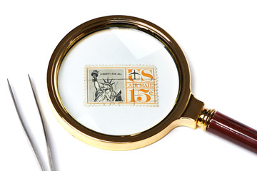 Old used postage stamp and magnifier