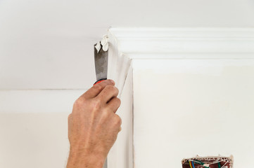 Installation of ceiling moldings.
