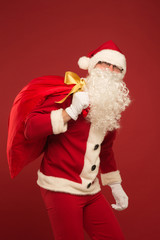 Portrait of happy Santa Claus with a huge sack